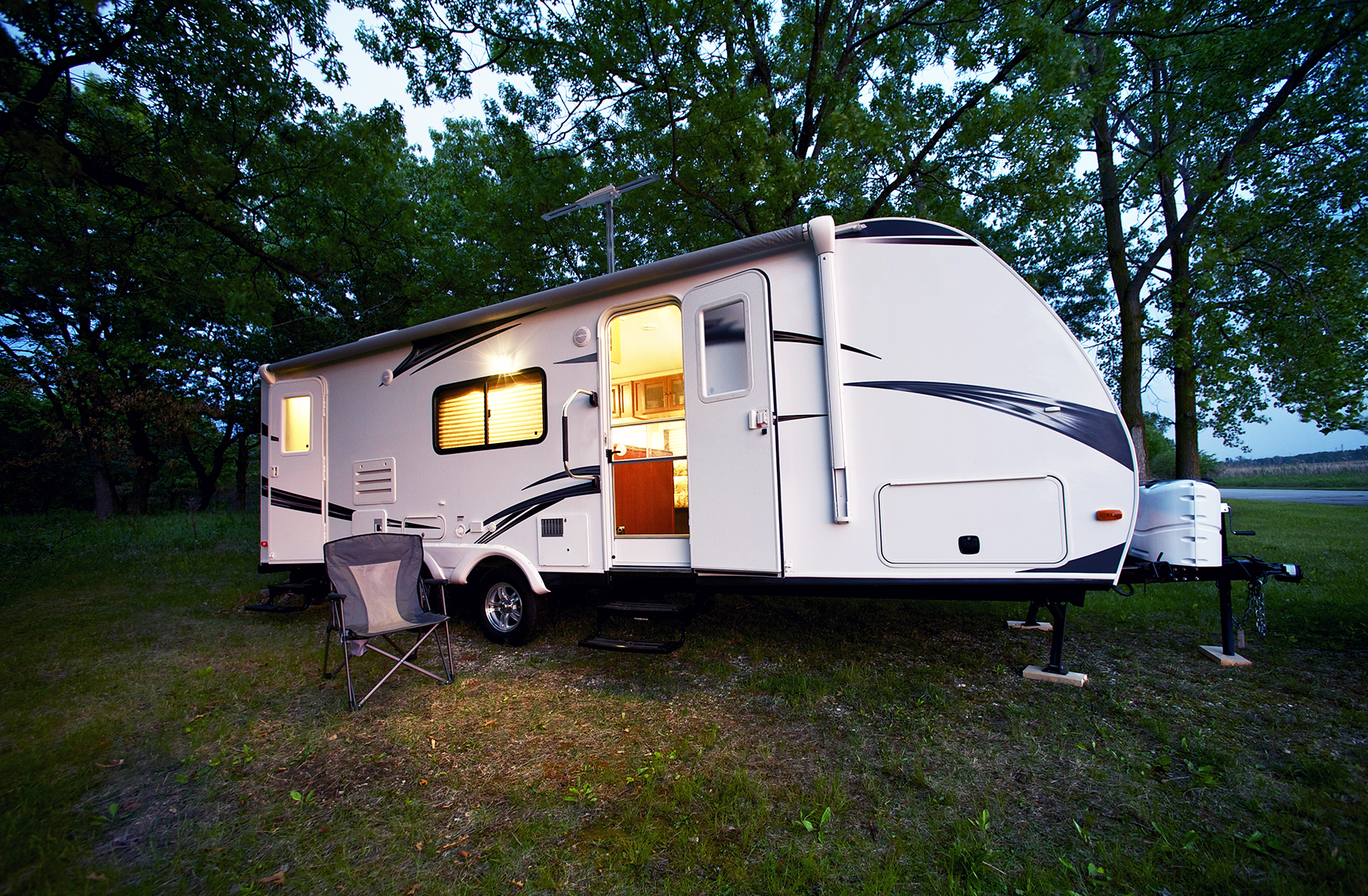 Recreation vehicle trailer parked at a forest campsite after an RV inspection