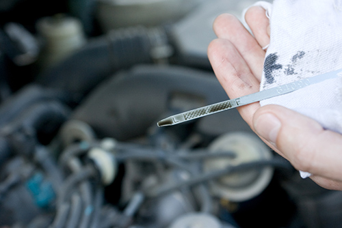 checking the engine oil while preforming rv inspection services